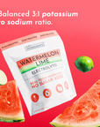 White pouch of watermelon lime electrolytes surrounded by fresh watermelon slices and lime on coral background.