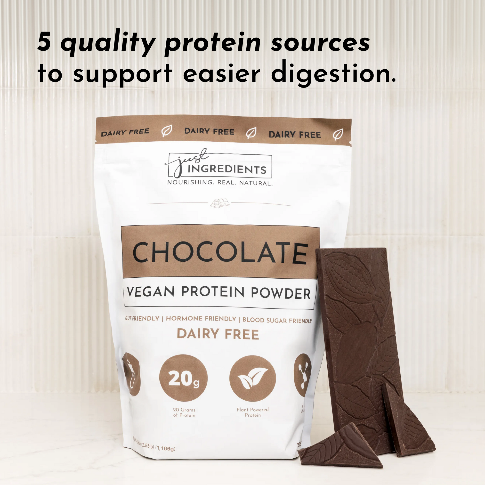 Brown and white bag of vegan chocolate protein powder next to chocolate bars, featuring nutritional information.