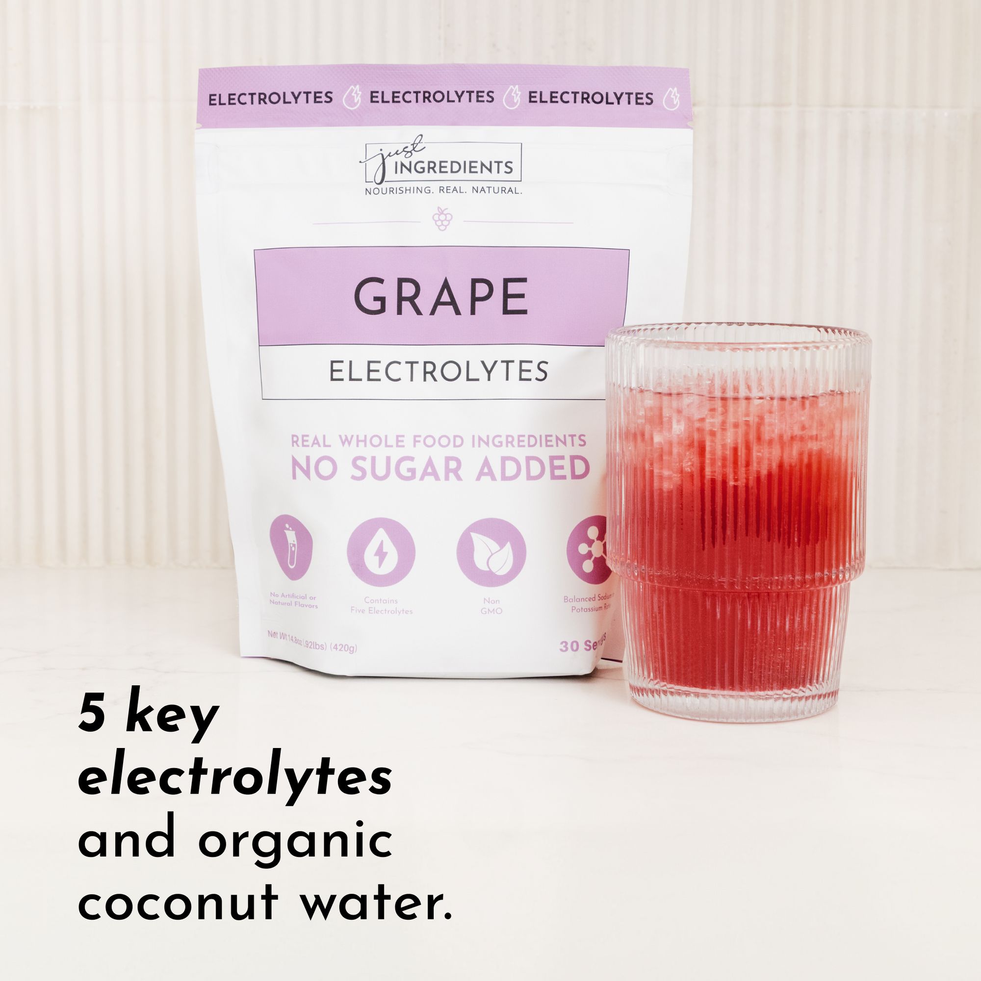 Purple packaging labeled "Grape Electrolytes" next to a glass of red liquid with ice.