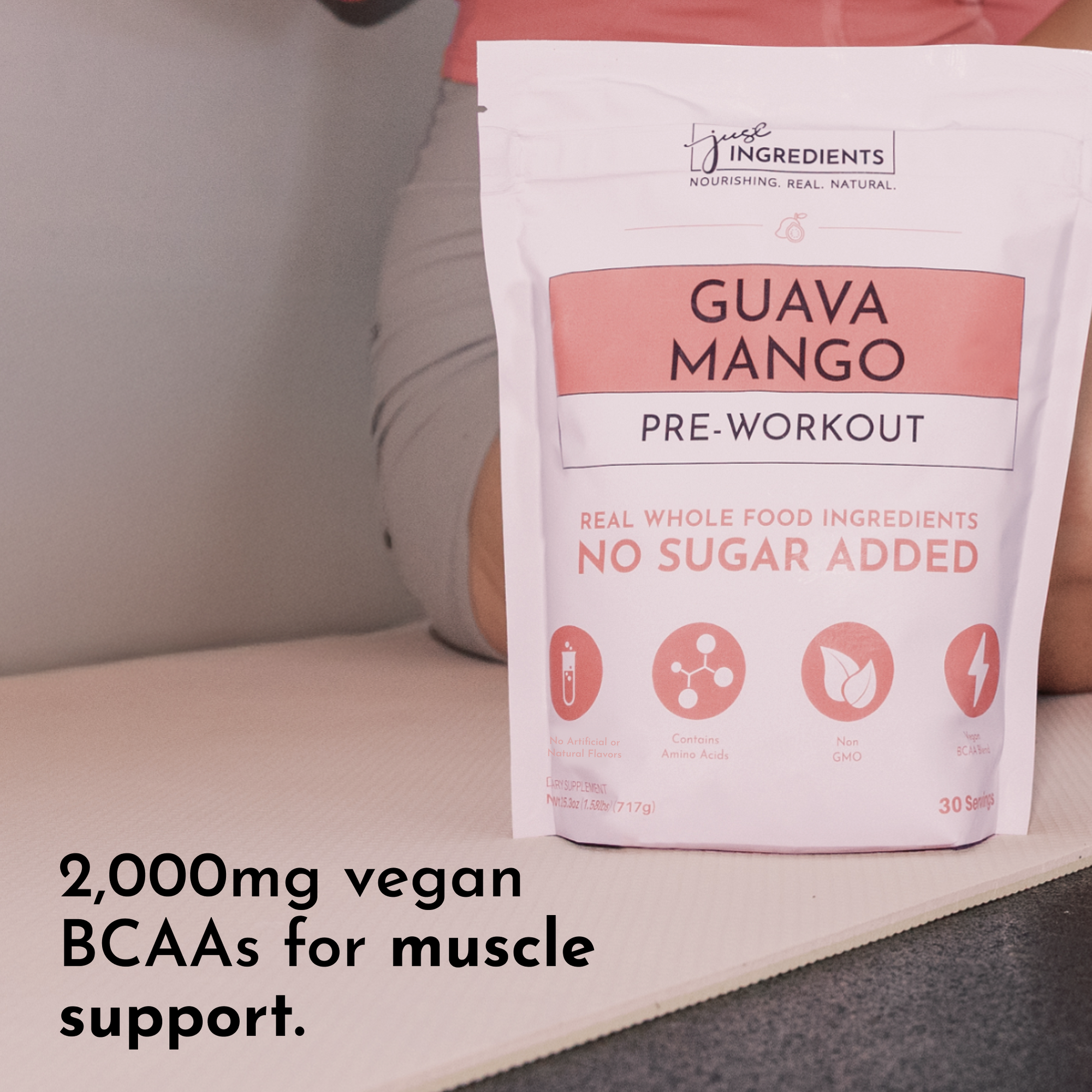White pouch of Guava Mango pre-workout powder with pink label showing "no sugar added" and ingredient icons, 30 servings.