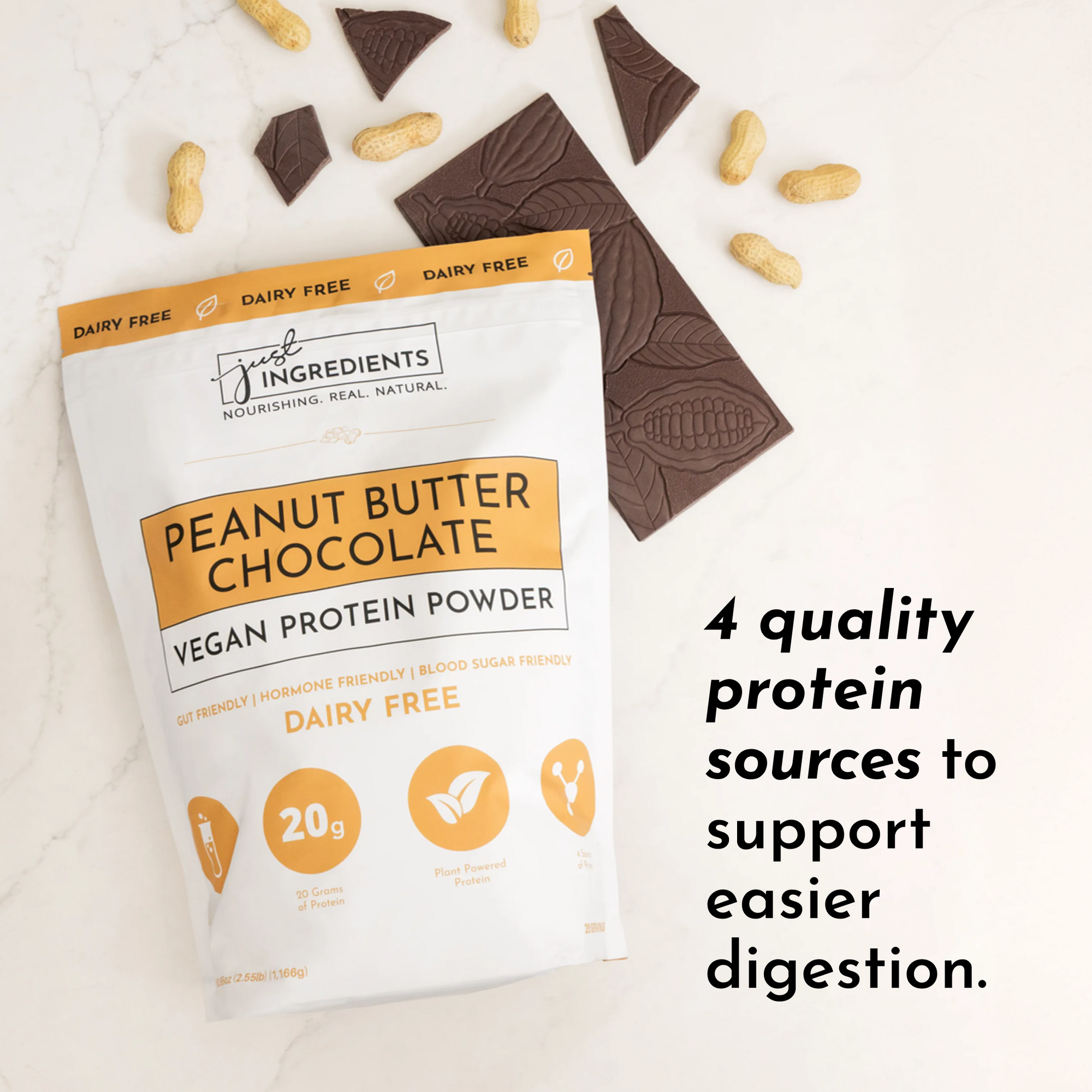 Vegan peanut butter chocolate protein powder bag with chocolate pieces and peanuts on a marble surface.