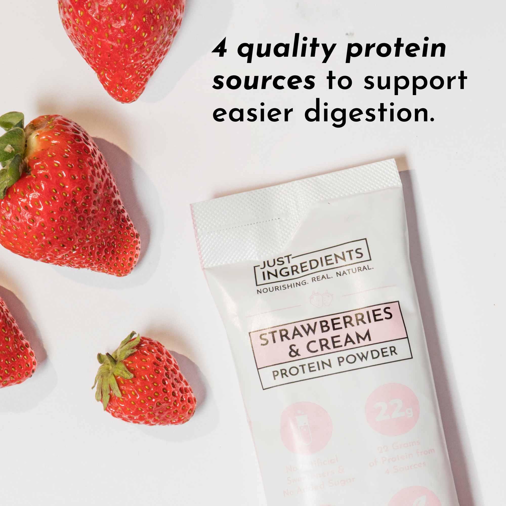 Strawberries and cream protein powder stick next to fresh strawberries on a white background.