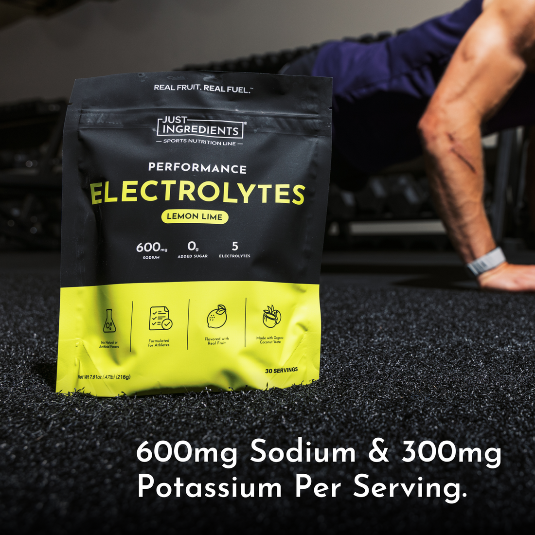 Lemon lime electrolyte packet on a gym floor with an athlete in the background.