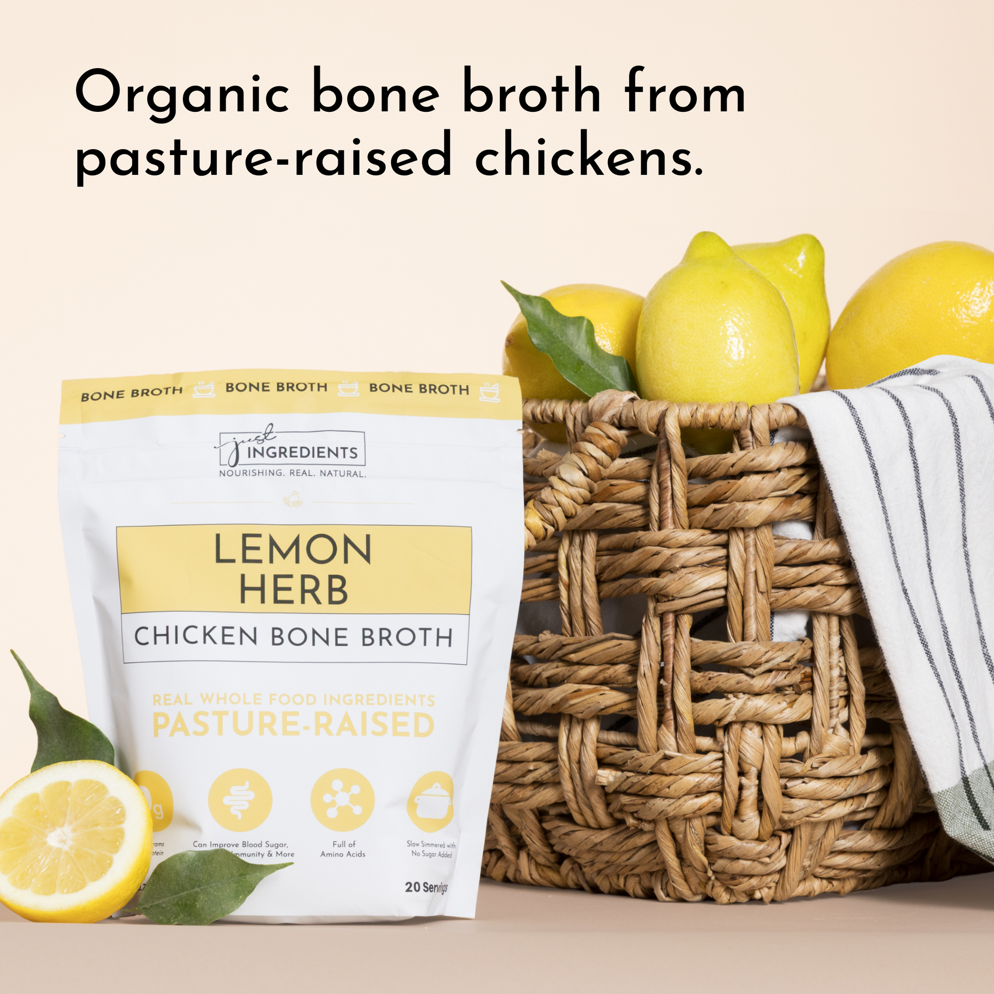 Pouch of Lemon Herb Chicken Bone Broth next to fresh lemons and a woven basket.