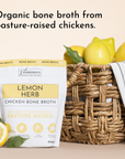 Pouch of Lemon Herb Chicken Bone Broth next to fresh lemons and a woven basket.