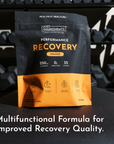Black and orange pouch of Just Ingredients Performance Recovery drink in orange flavor with nutrition details and benefit ico