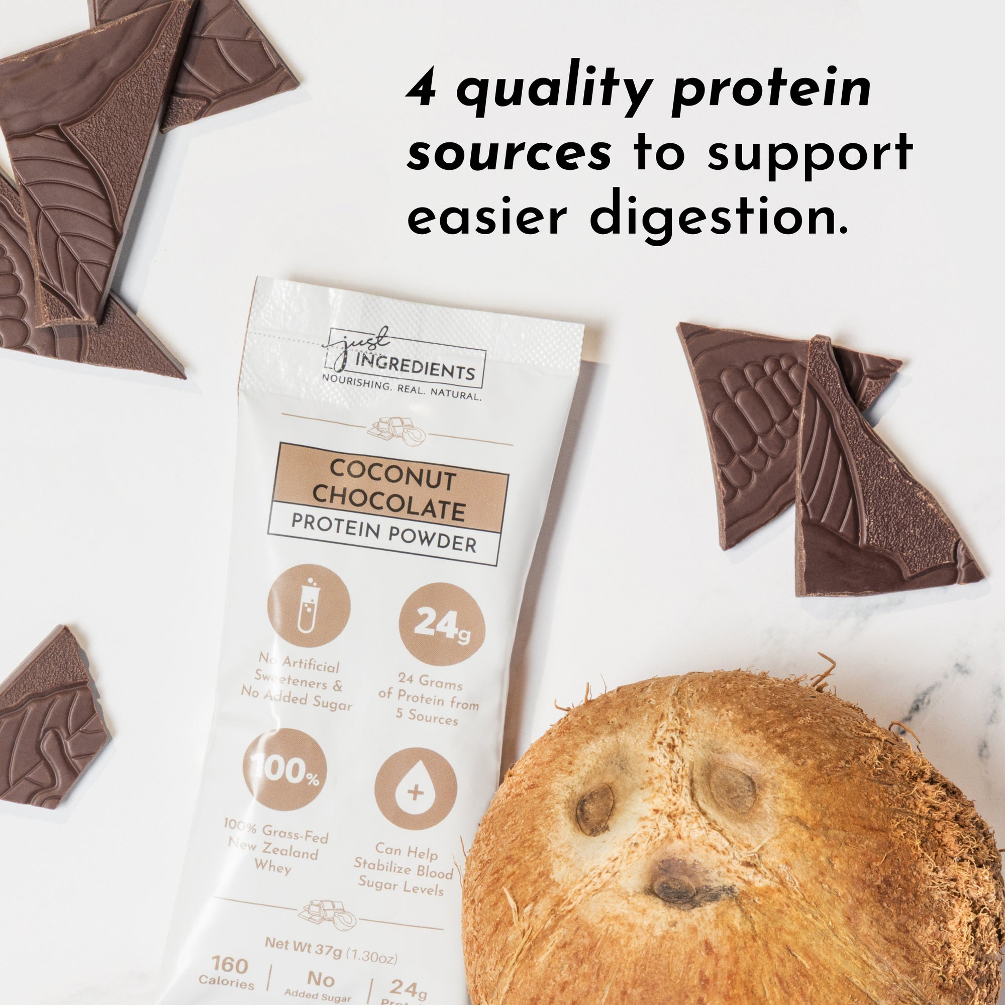 Coconut chocolate protein powder stick next to chocolate pieces and a coconut with a face.