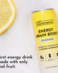 Yellow can of lemonade energy drink next to a lemon slice on a light background.