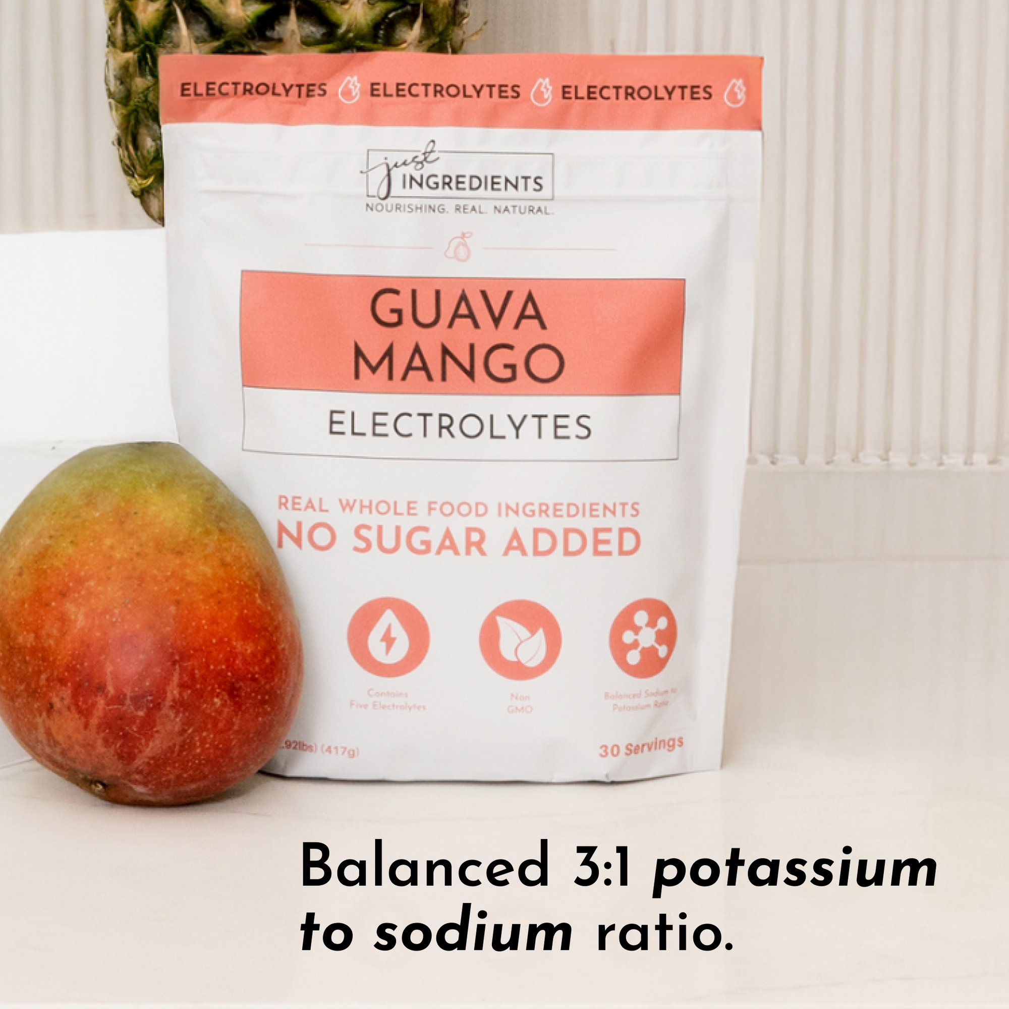 Pouch of Guava Mango Electrolytes with a mango in front, featuring a balanced potassium to sodium ratio.