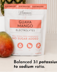 Pouch of Guava Mango Electrolytes with a mango in front, featuring a balanced potassium to sodium ratio.