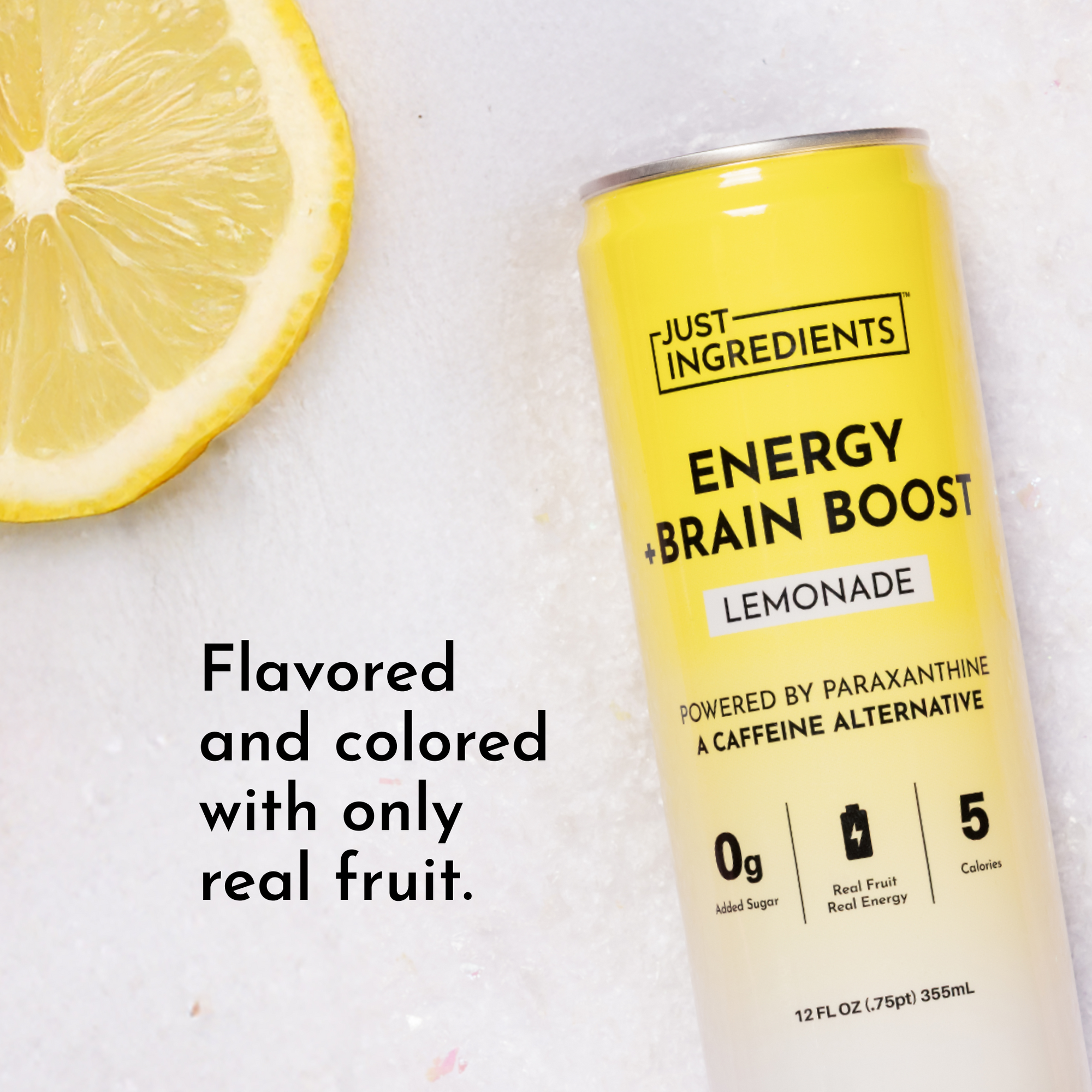 Yellow can of lemonade energy drink next to a lemon slice on a light surface.