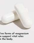 Two white capsule pills on a light gray background.