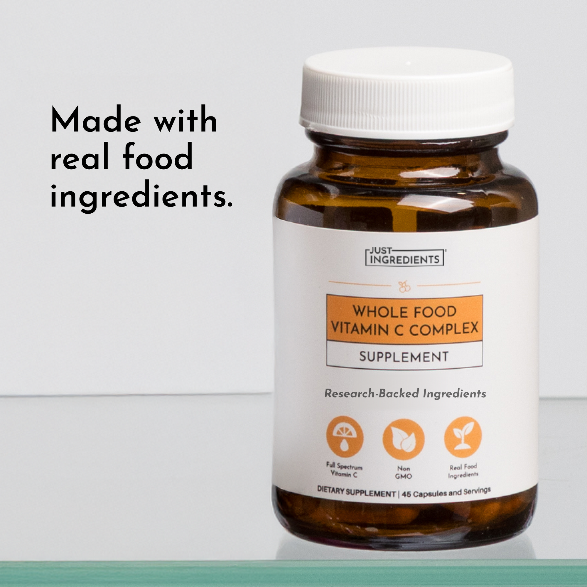 Amber glass bottle with white cap containing Whole Food Vitamin C Complex supplement capsules.