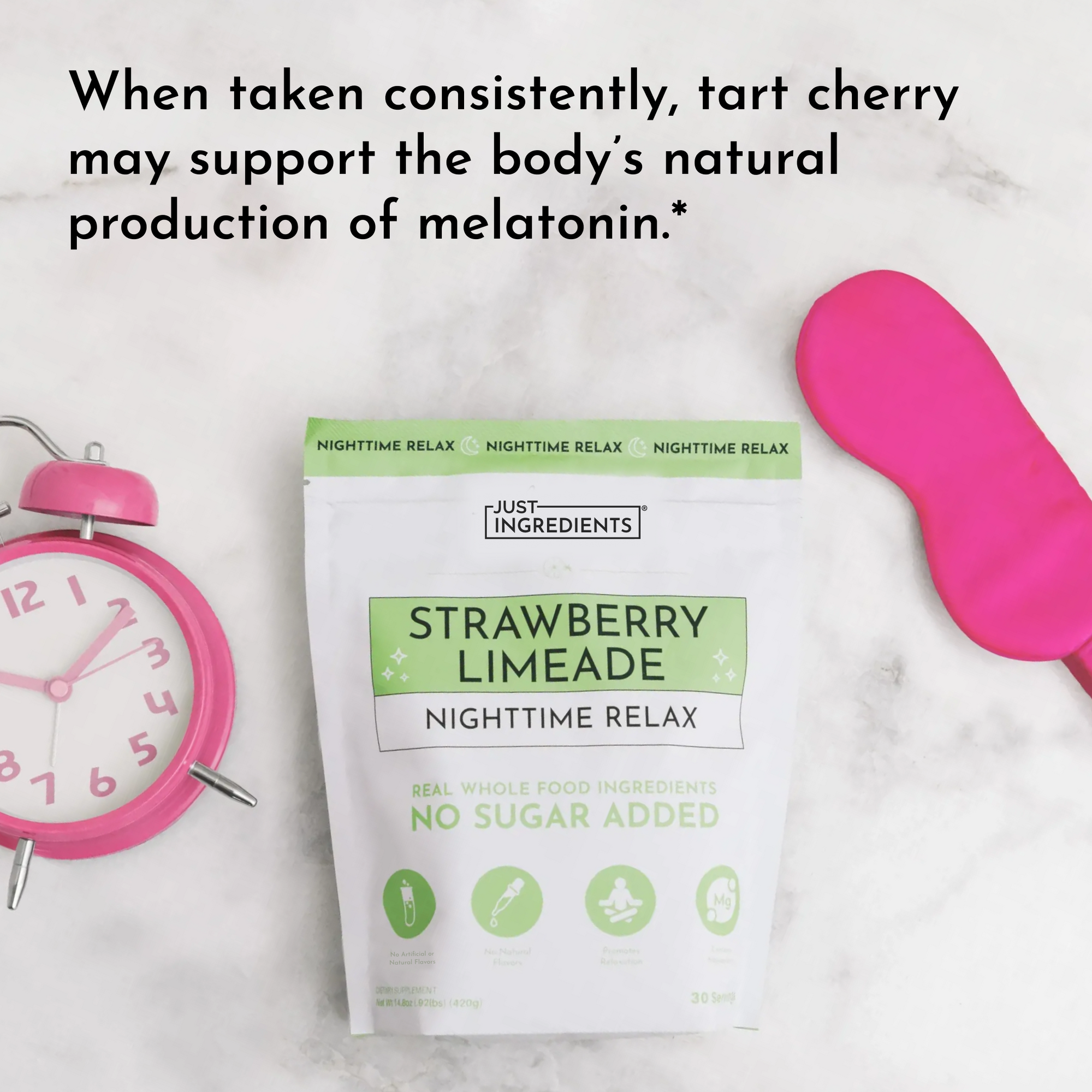 Strawberry Limeade Nighttime Relax pouch with pink alarm clock and sleep mask on marble surface.