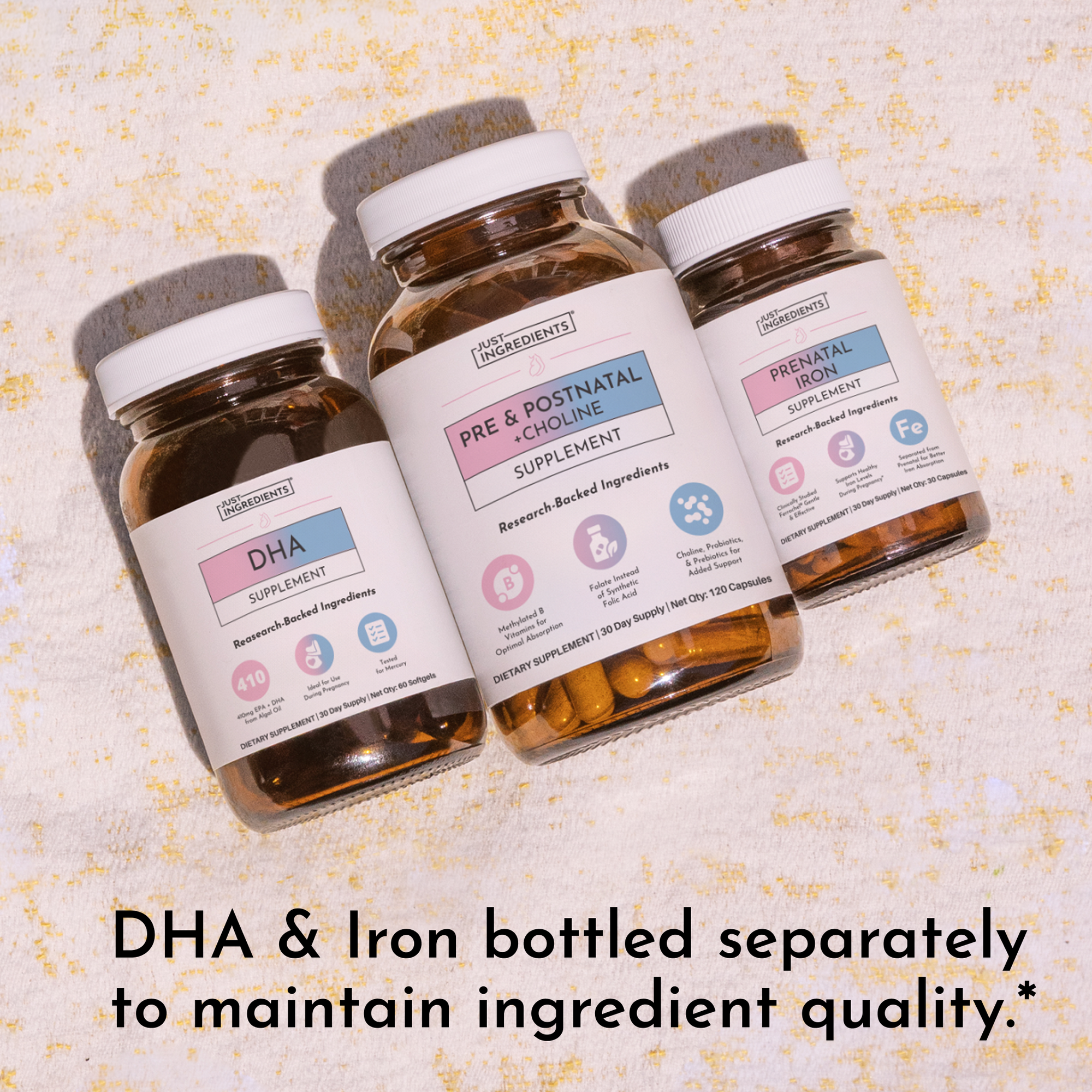 Three amber glass supplement bottles with white caps labeled DHA, Pre &amp; Postnatal Choline, and Prenatal Iron on textured back