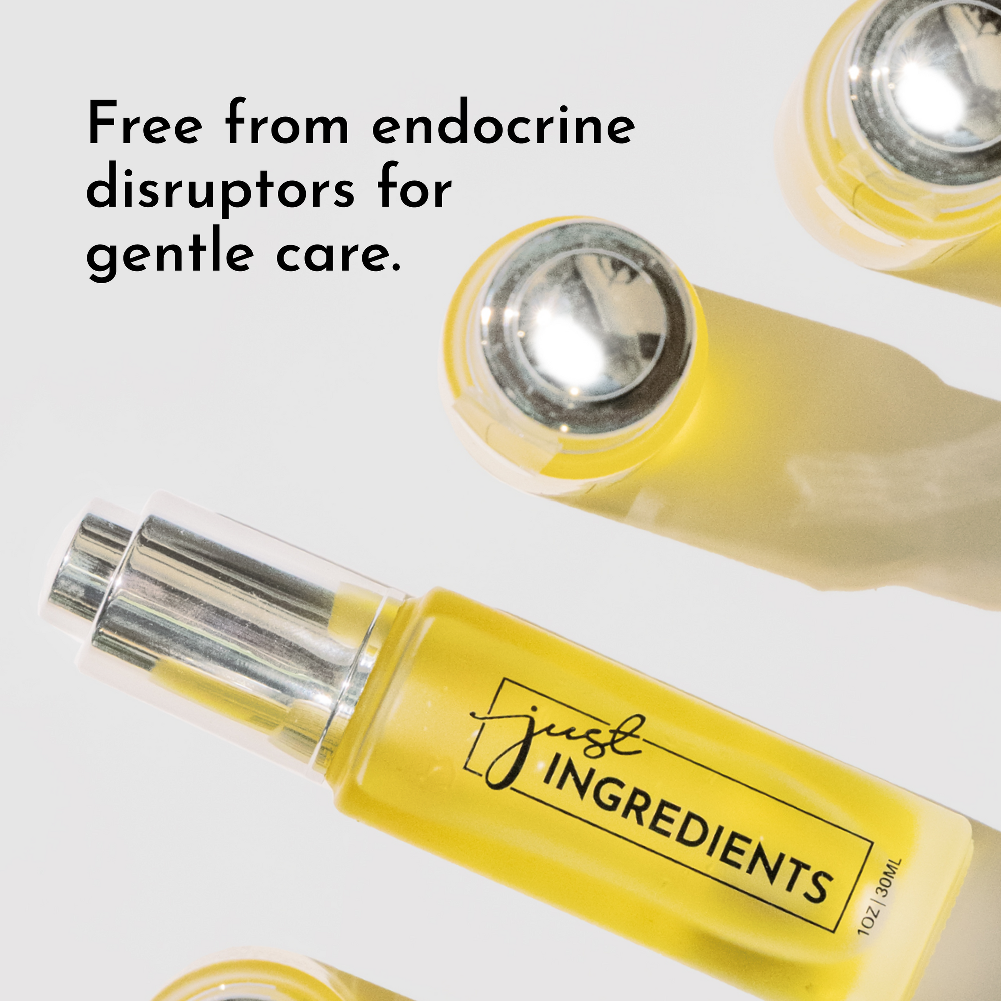 Yellow face serum bottle with a silver pump, labeled "just INGREDIENTS," on a white background.