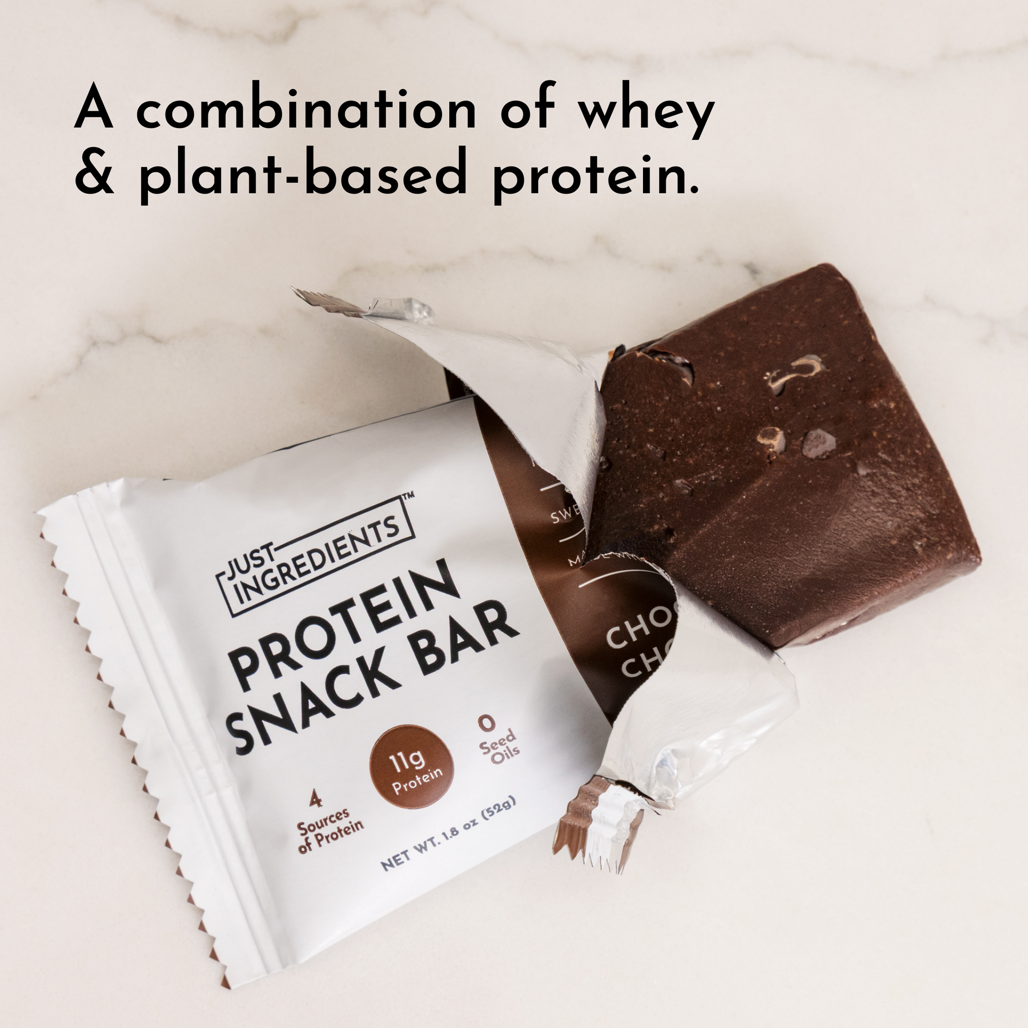 Chocolate protein snack bar partially unwrapped, showing a rich chocolate color and packaging details.