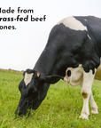 Black and white cow grazing in a field with text 'Made from grass-fed beef bones'.