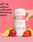Can of clear protein drink labeled "Strawberry Limeade" with strawberries and limes on a pink background.