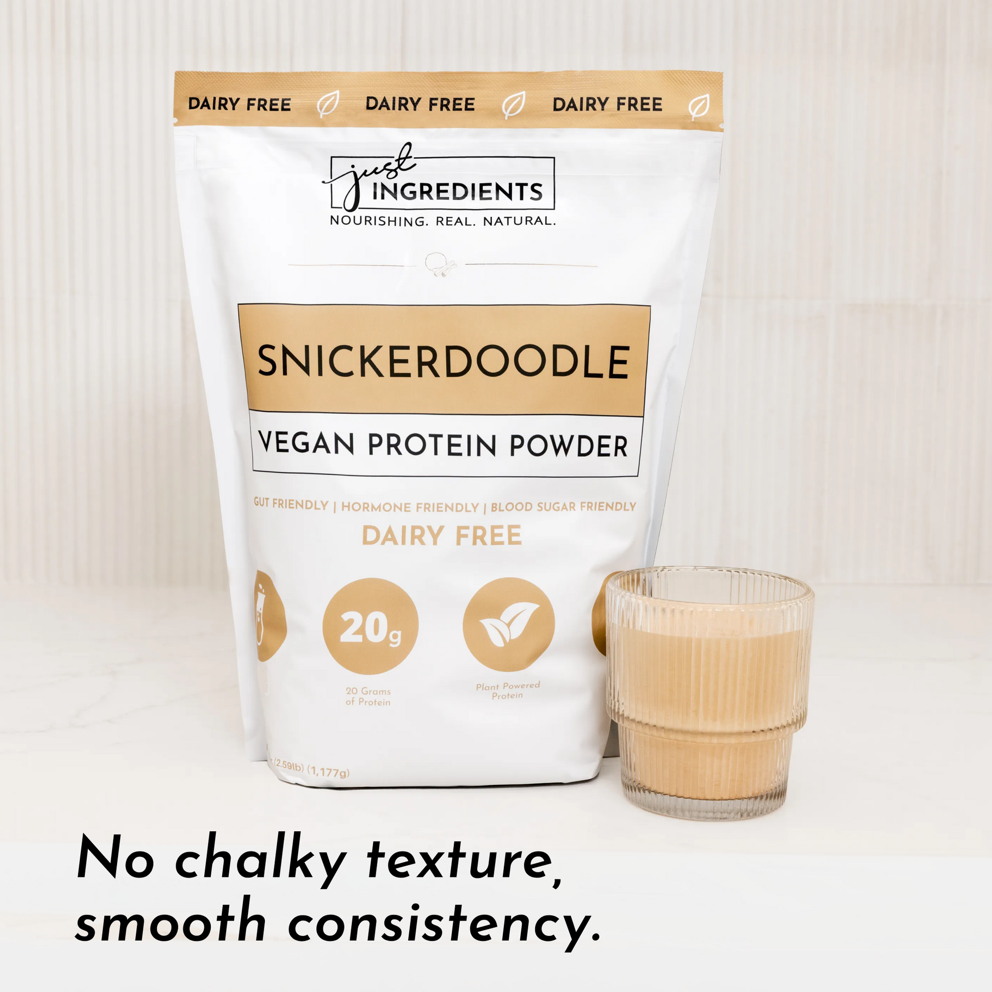 Vegan Snickerdoodle protein powder bag next to a glass of smooth protein shake.