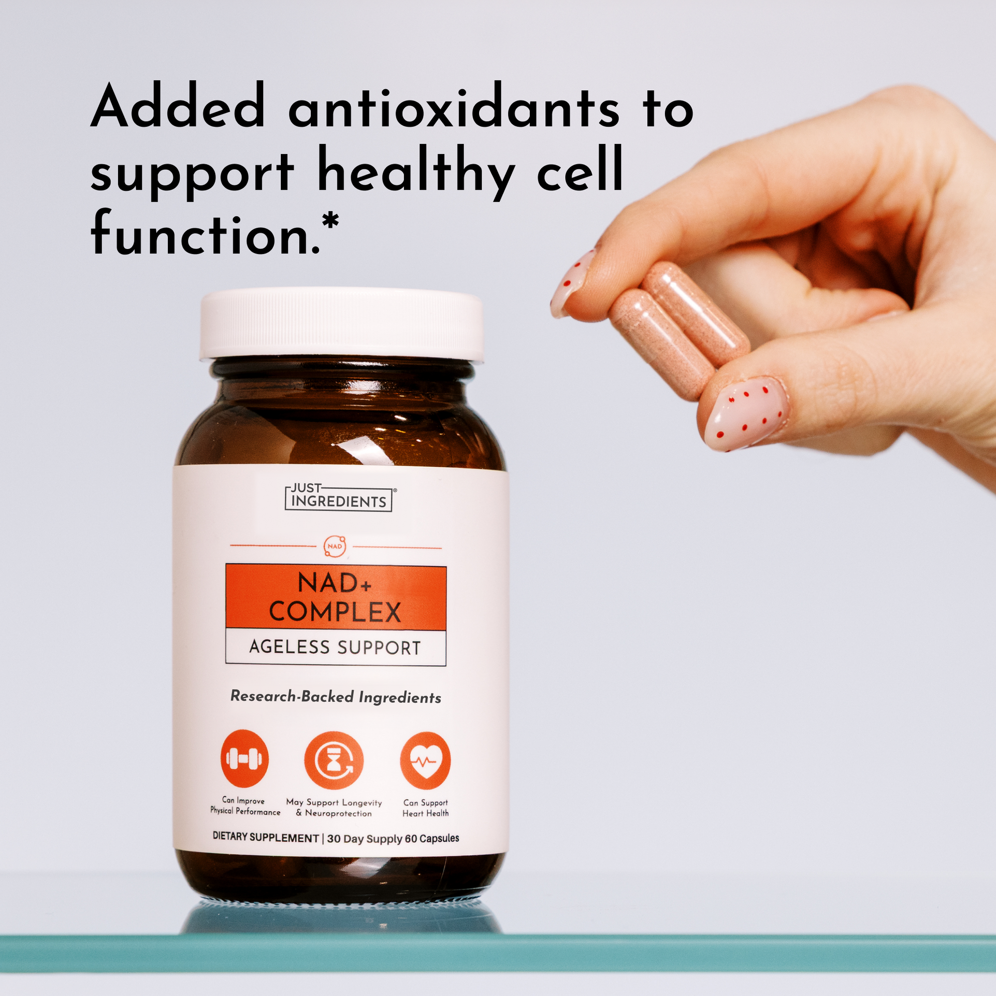 Hand holding amber glass bottle of NAD+ Complex dietary supplement capsules with white label and orange accent panel.