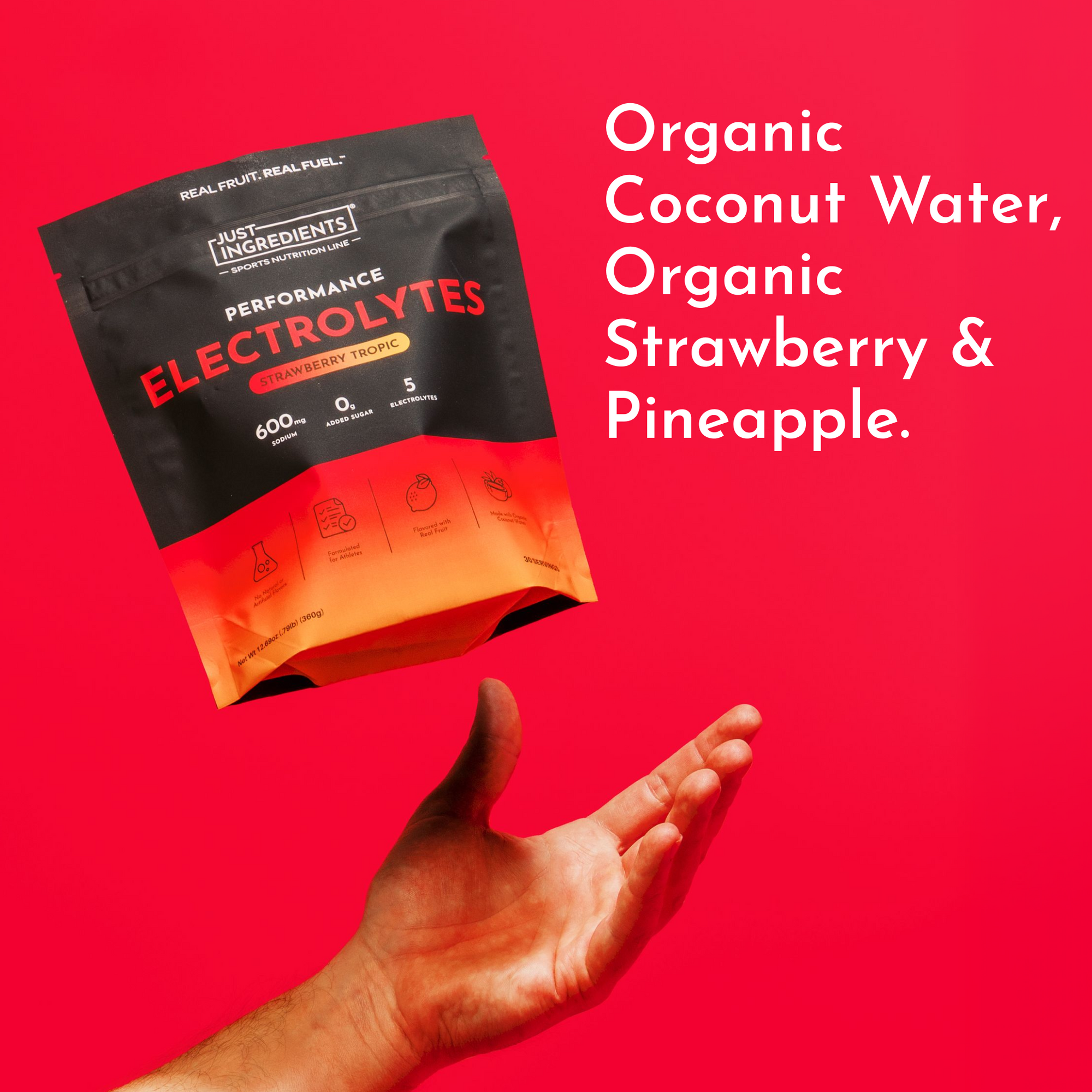 Black and orange electrolyte packets with strawberry tropic flavor labeling above an open hand on red background.