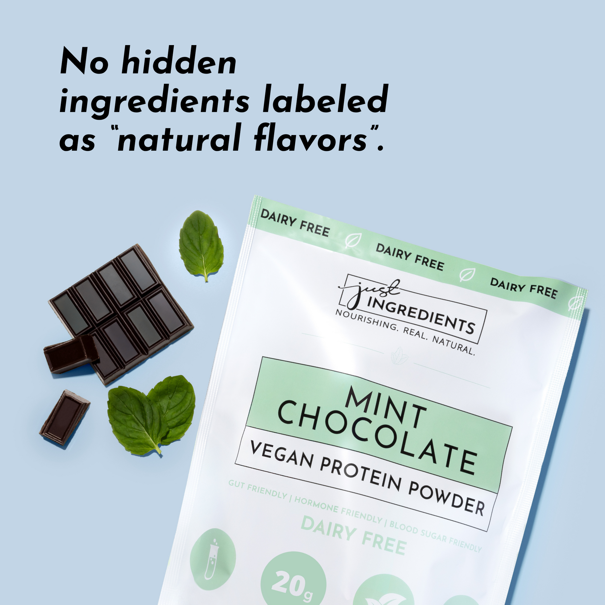 Mint chocolate protein powder package with chocolate pieces and mint leaves on a light background.