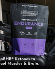 Black and purple pouch of grape-flavored endurance drink powder with nutrition information and ingredient details displayed o