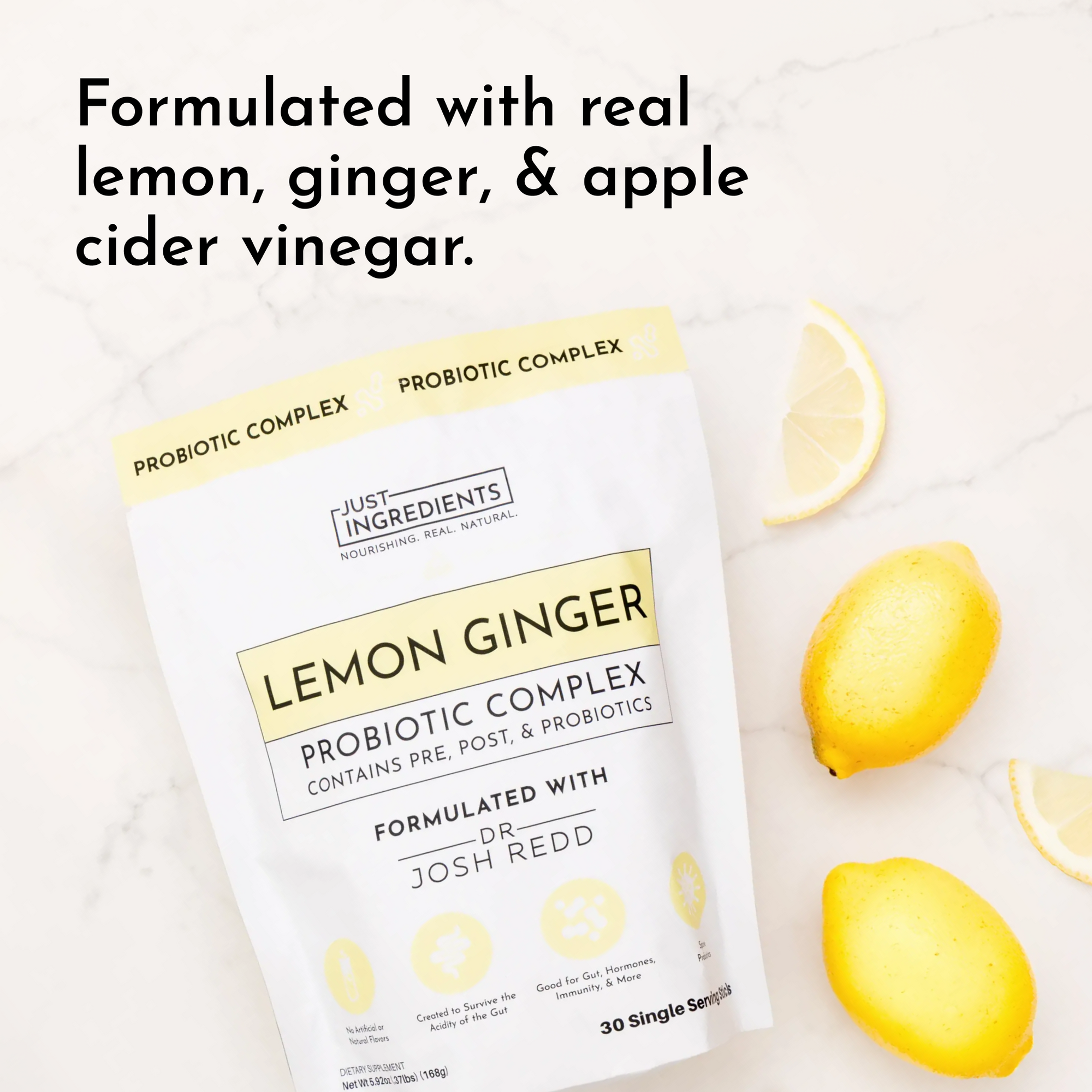 Probiotic complex package with yellow design, featuring lemons and ginger on a marble surface.