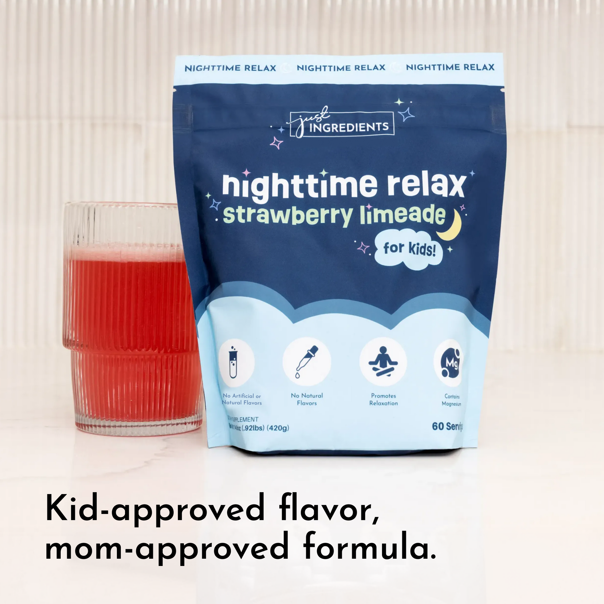 Dark blue pouch of strawberry limeade nighttime relax powder next to a glass filled with red liquid.