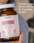 Brown bottle of women's multivitamin supplement with a label detailing its benefits and ingredients.