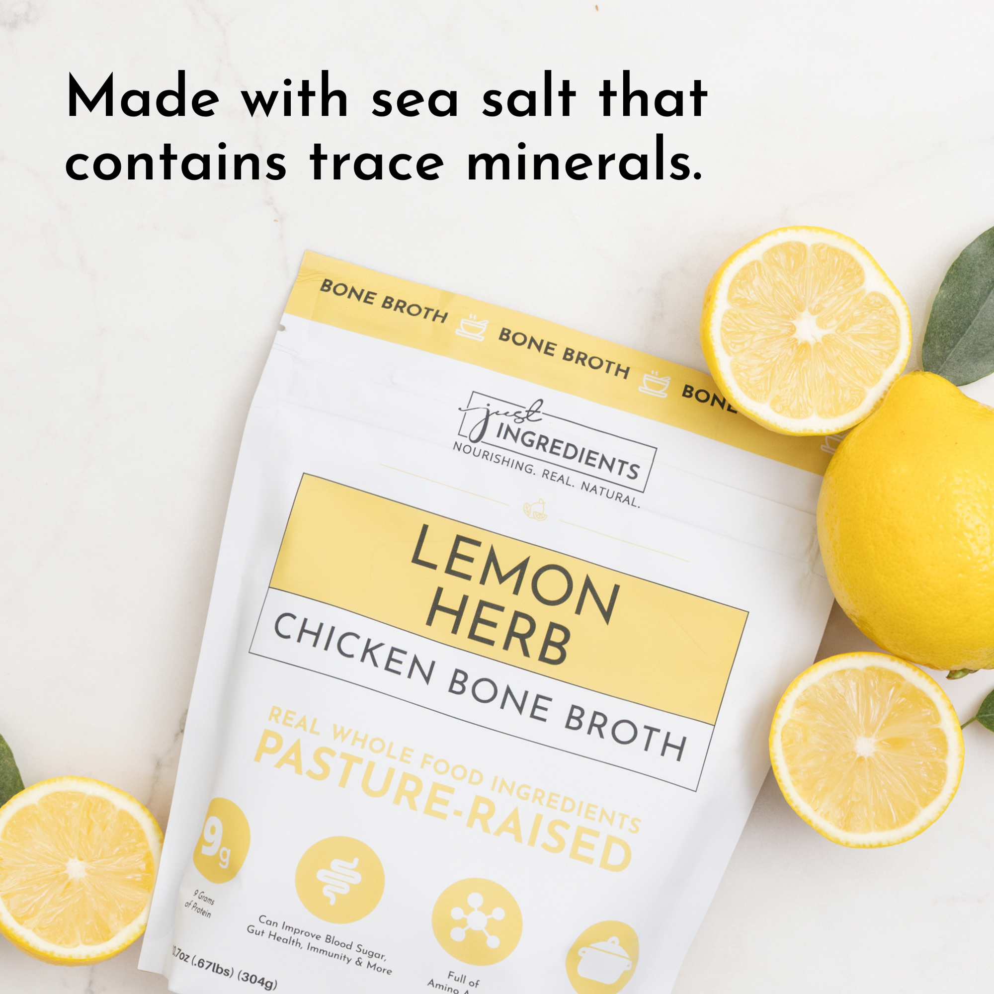 Pouch of Lemon Herb Chicken Bone Broth with lemon slices and green leaves on a light surface.