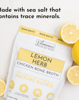 Pouch of Lemon Herb Chicken Bone Broth with lemon slices and green leaves on a light surface.