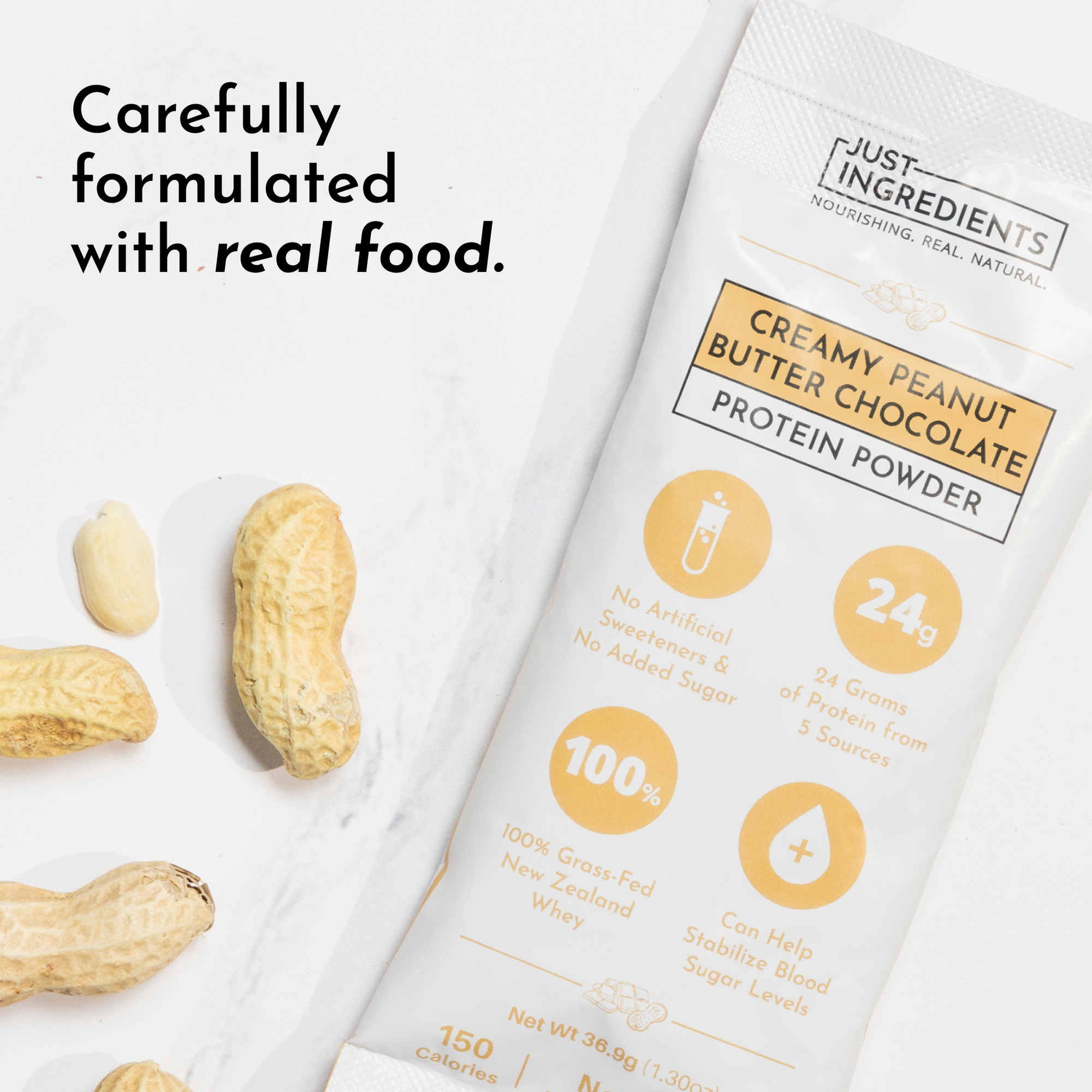 Peanut butter and chocolate protein powder stick next to whole peanuts on a marble surface.