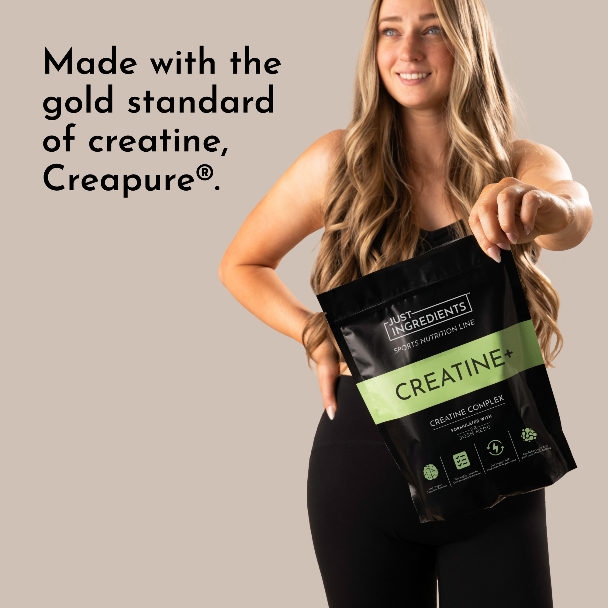Woman holding a black pouch labeled "CREATINE+" with a green stripe, wearing a black outfit against a neutral background.