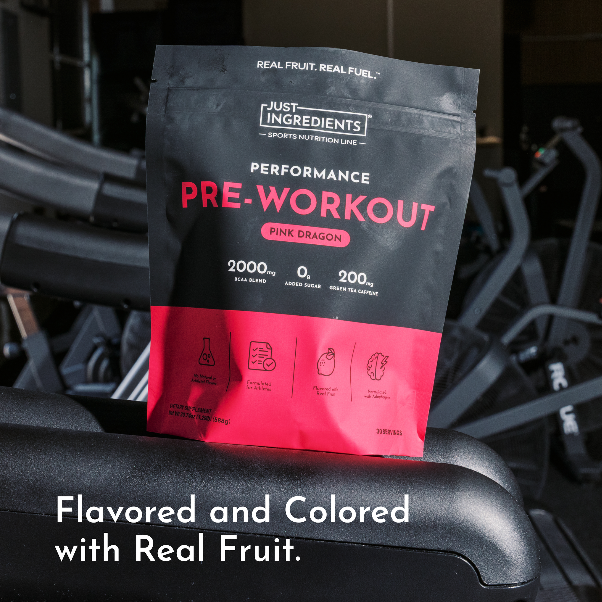 Black and pink pouch of Pink Dragon pre-workout powder with ingredient icons displayed on gym equipment.