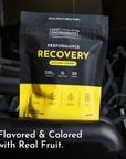 Black and yellow pouch of Just Ingredients Performance Recovery drink in Golden Cherry flavor with nutritional information di