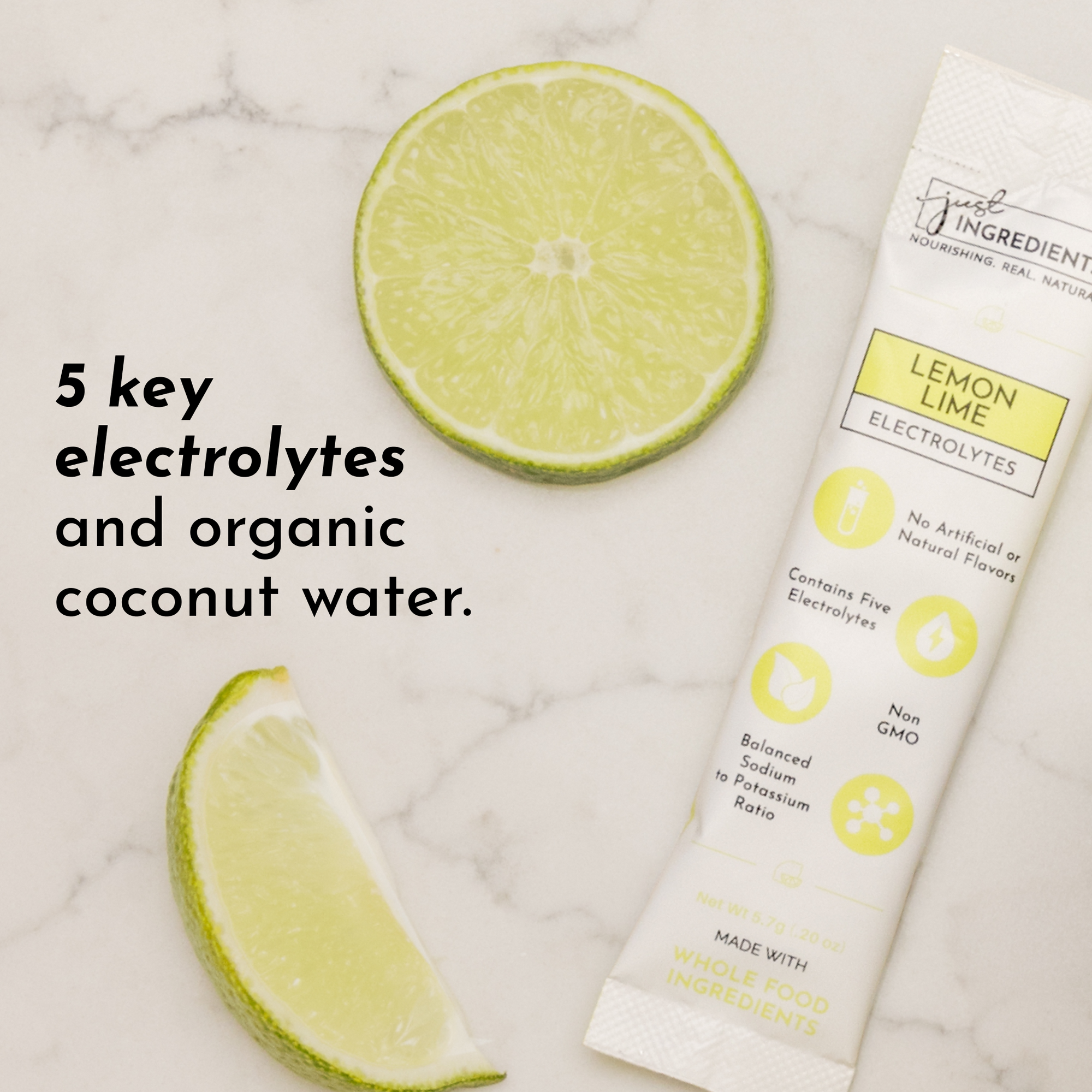 Lime slices and a stick pack of lemon lime electrolytes on a marble surface.