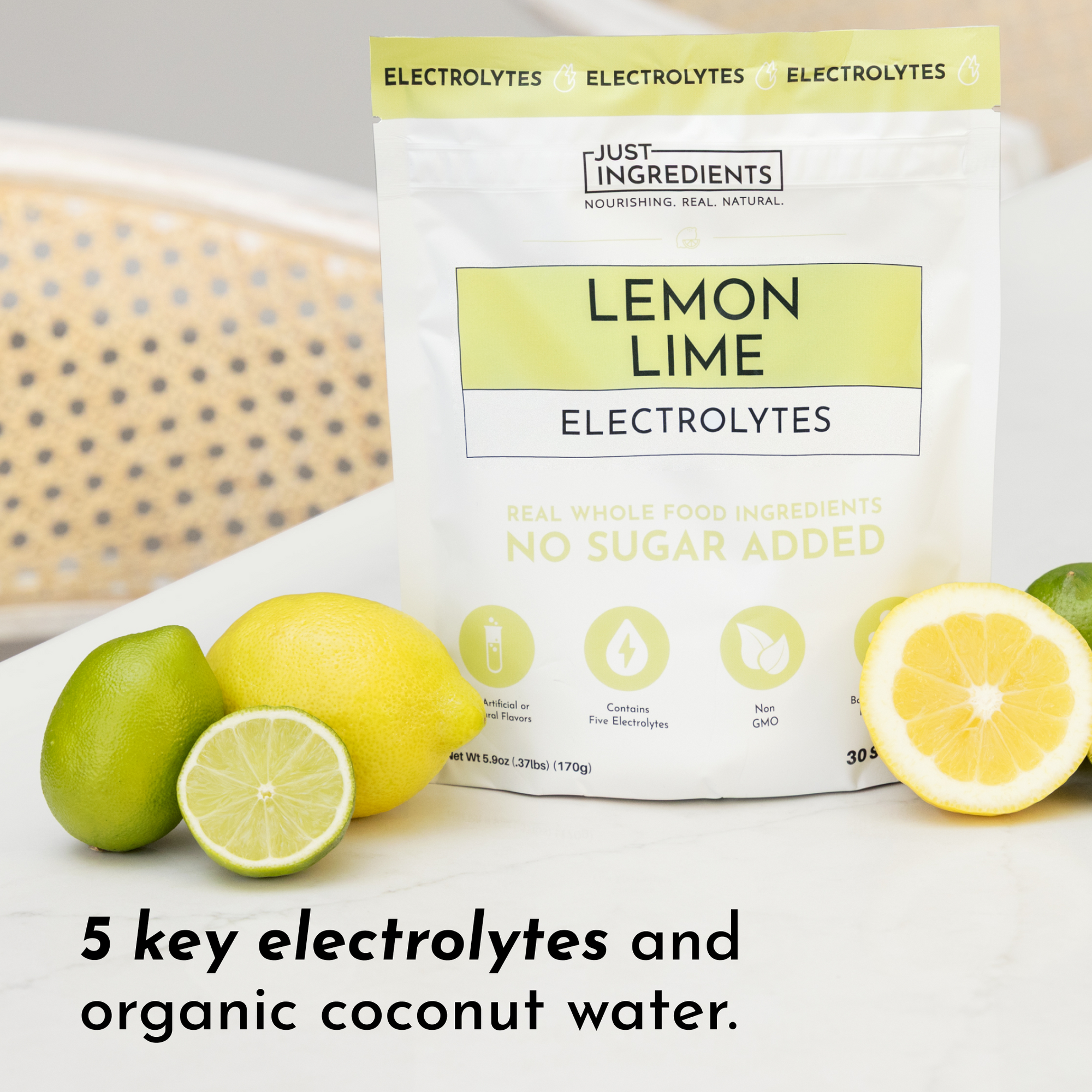 Pouch of Lemon Lime Electrolytes with whole lemons and limes on a surface, highlighting key ingredients.