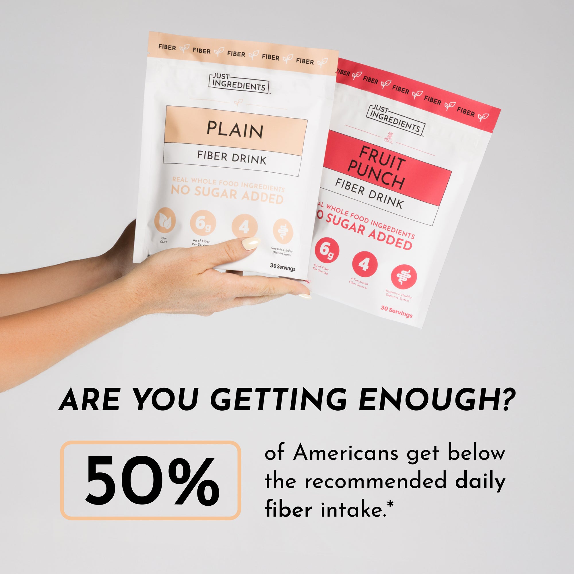 Two fiber drink packets held in hand: one labeled "Plain" and the other "Fruit Punch," both with 30 servings.