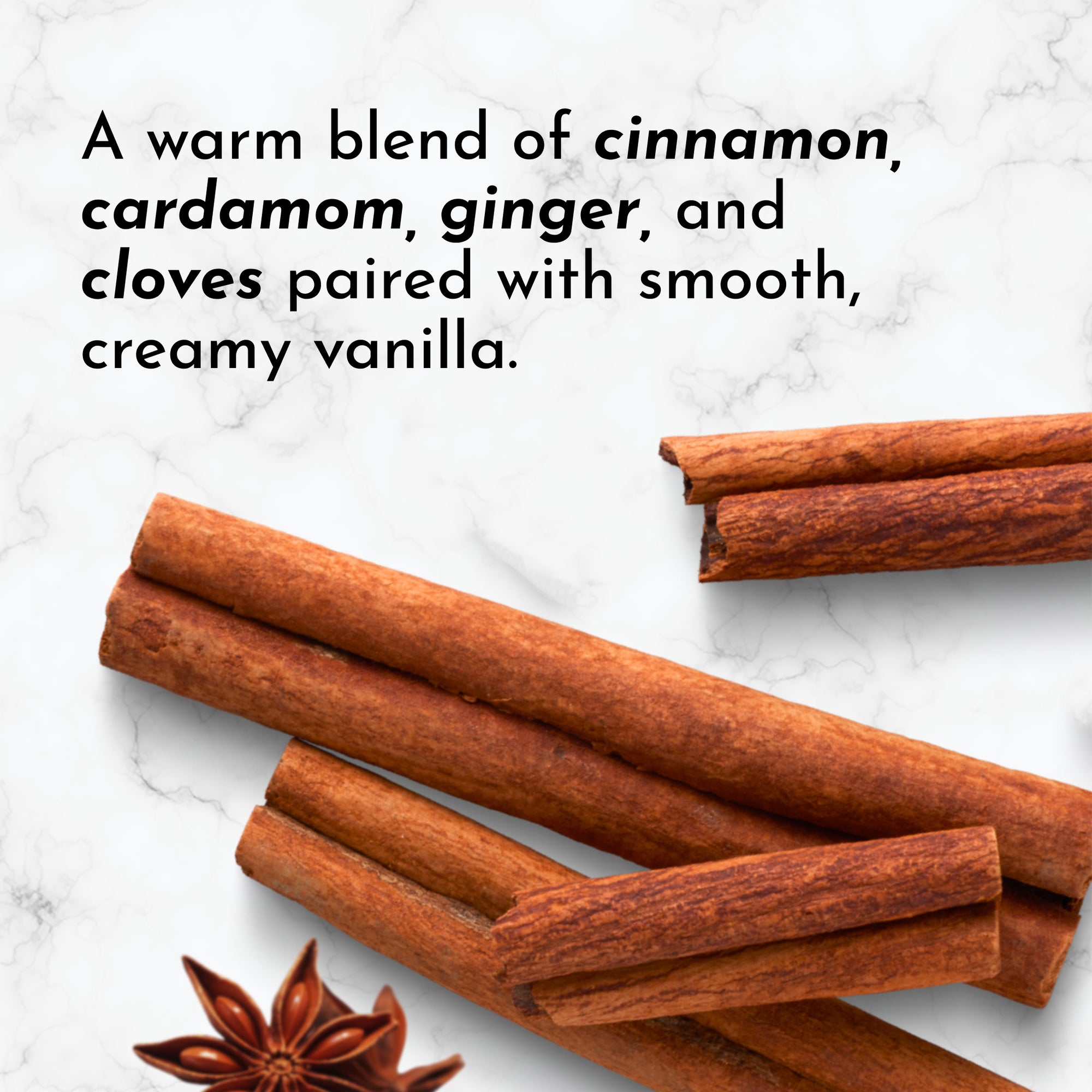 Cinnamon sticks arranged on a marble surface with star anise in the foreground.