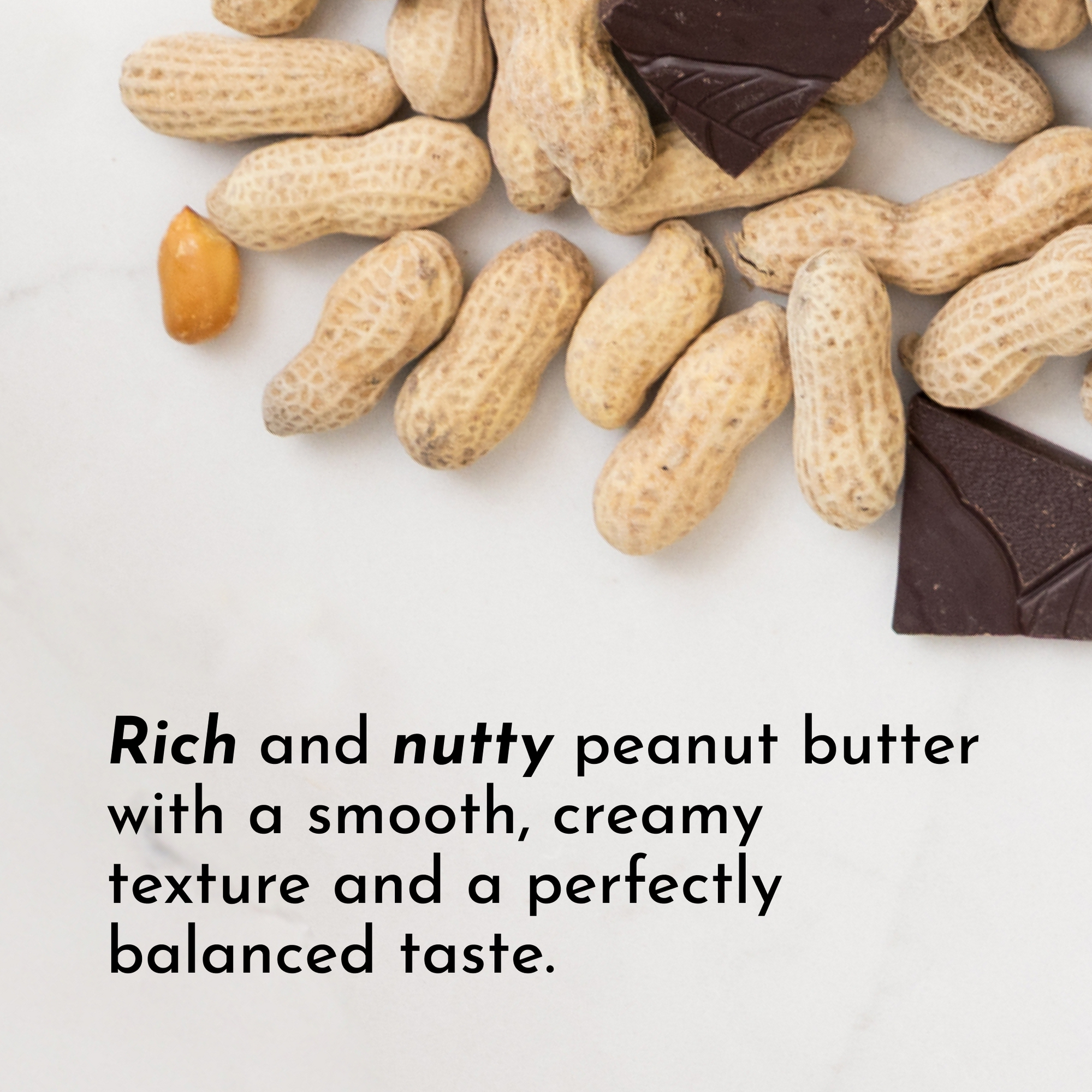 Peanuts and chocolate pieces arranged on a light surface, highlighting a creamy peanut butter theme.