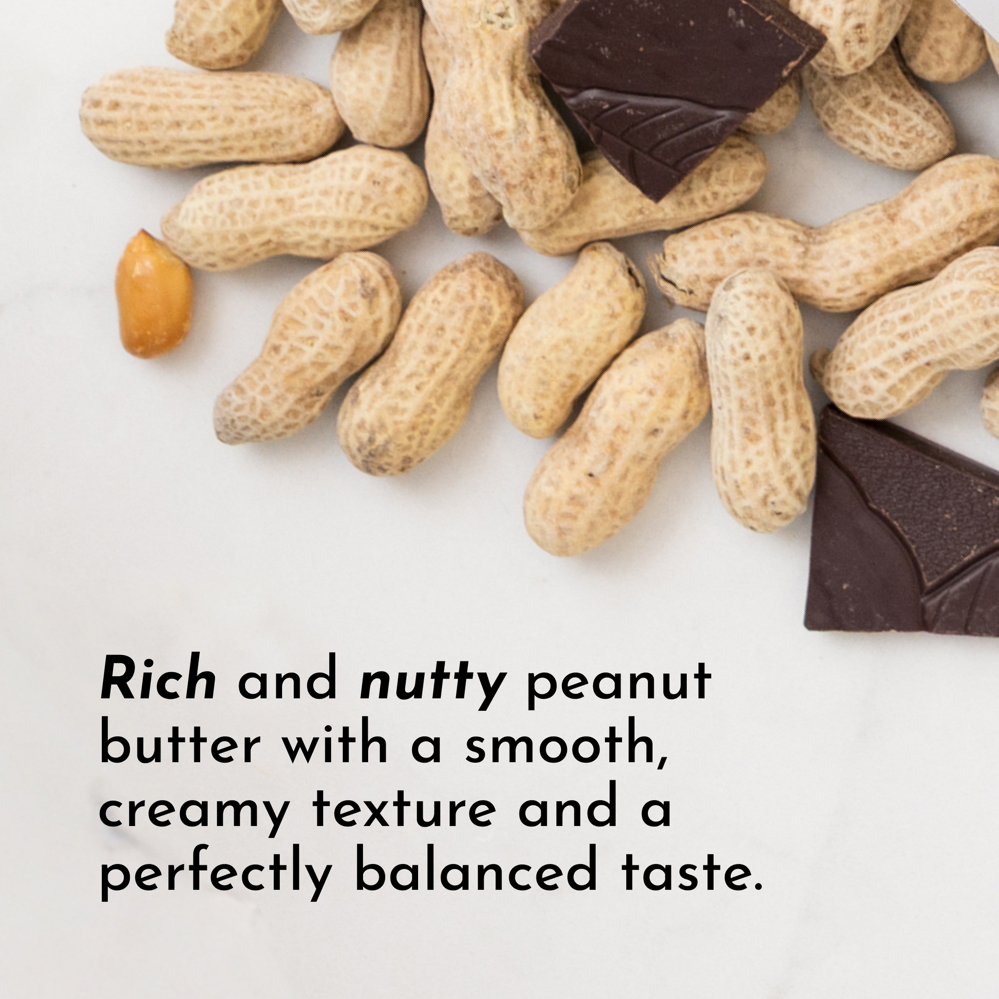 Peanuts and dark chocolate pieces arranged on a light surface.