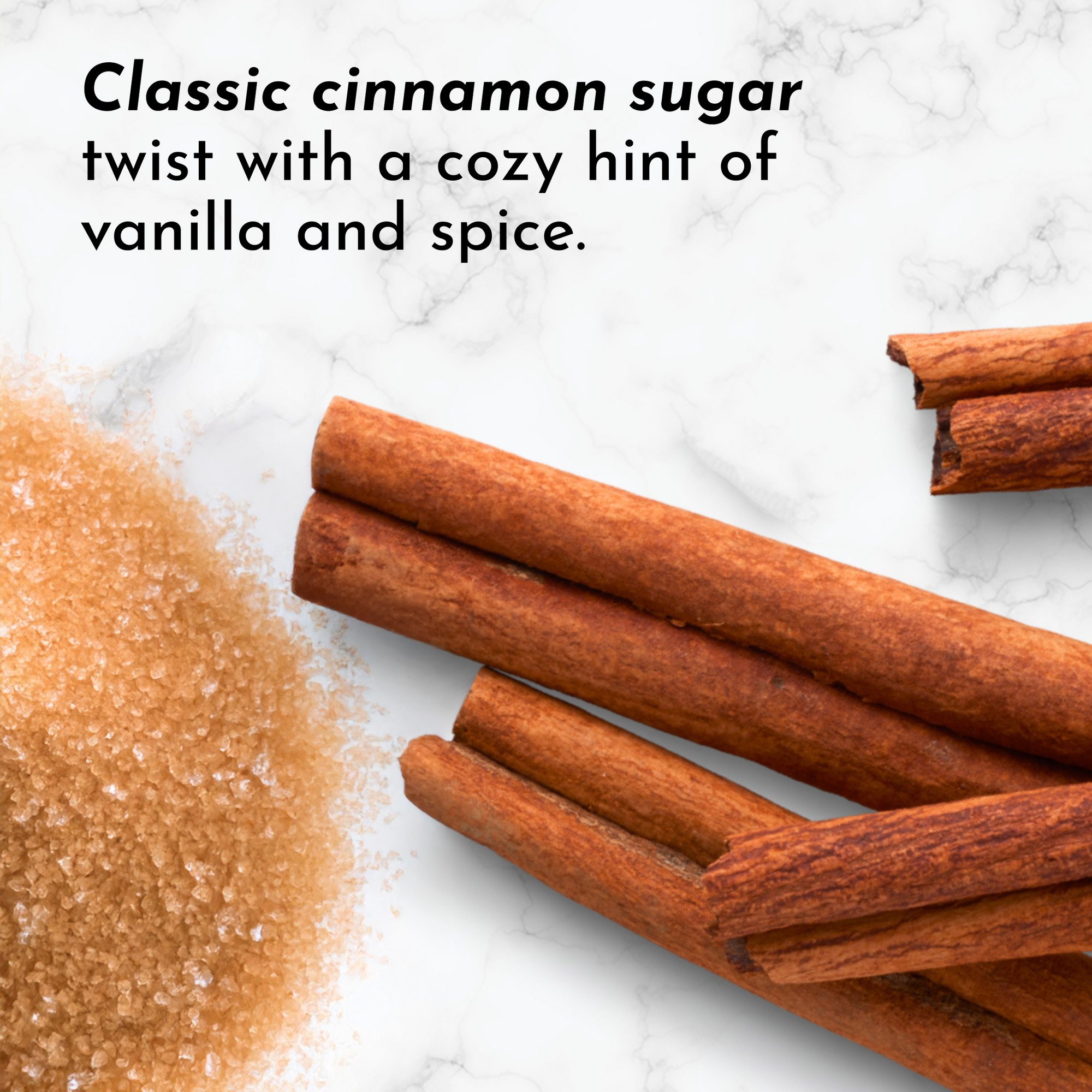 Cinnamon sticks and cinnamon sugar mixture on marble surface.