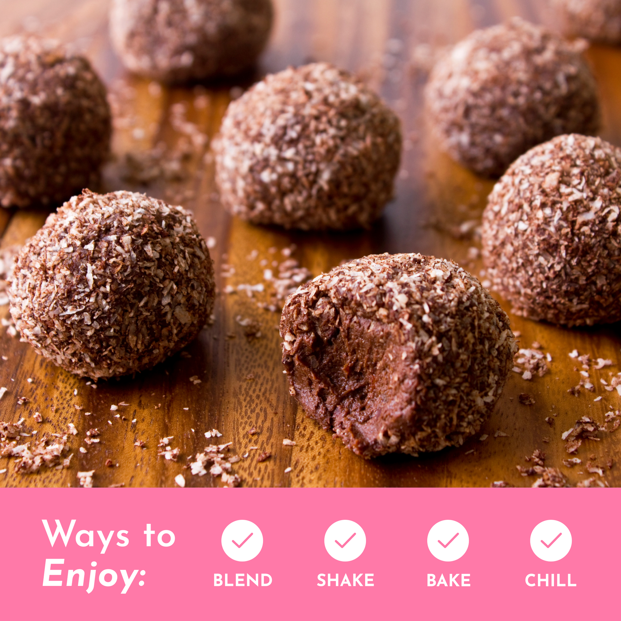 Chocolate protein balls coated in shredded coconut on a wooden surface.