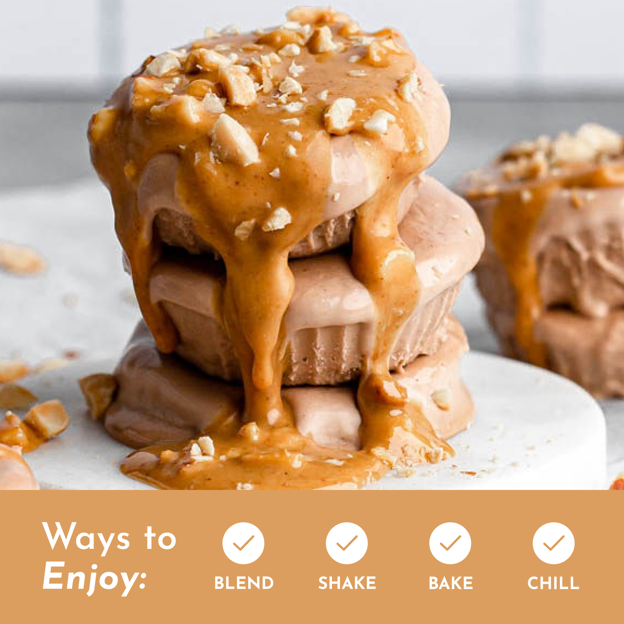 Stack of frozen protein desserts topped with peanut butter and chopped nuts on a white plate.