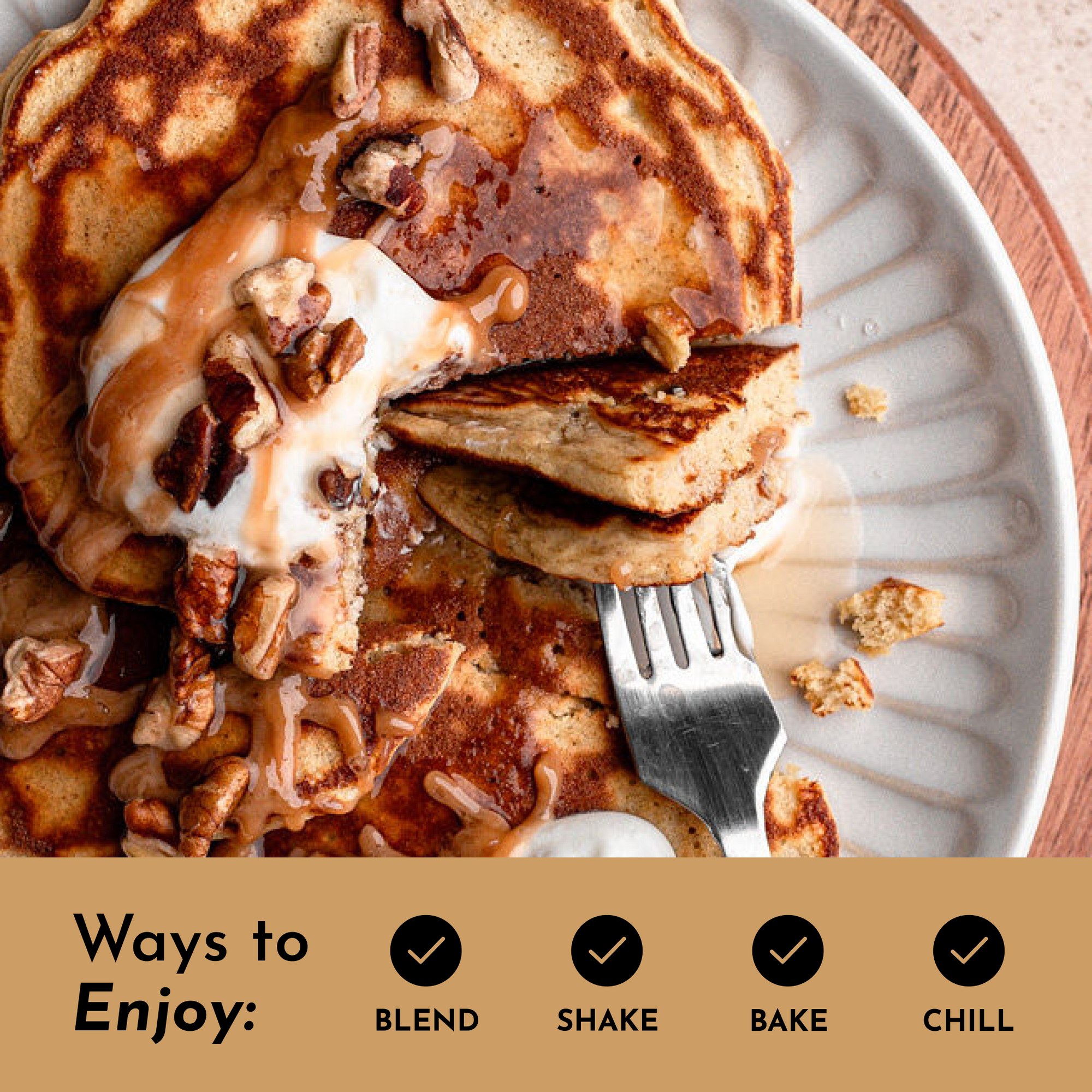Pancakes topped with caramel sauce, nuts, and a dollop of cream, served on a light-colored plate.