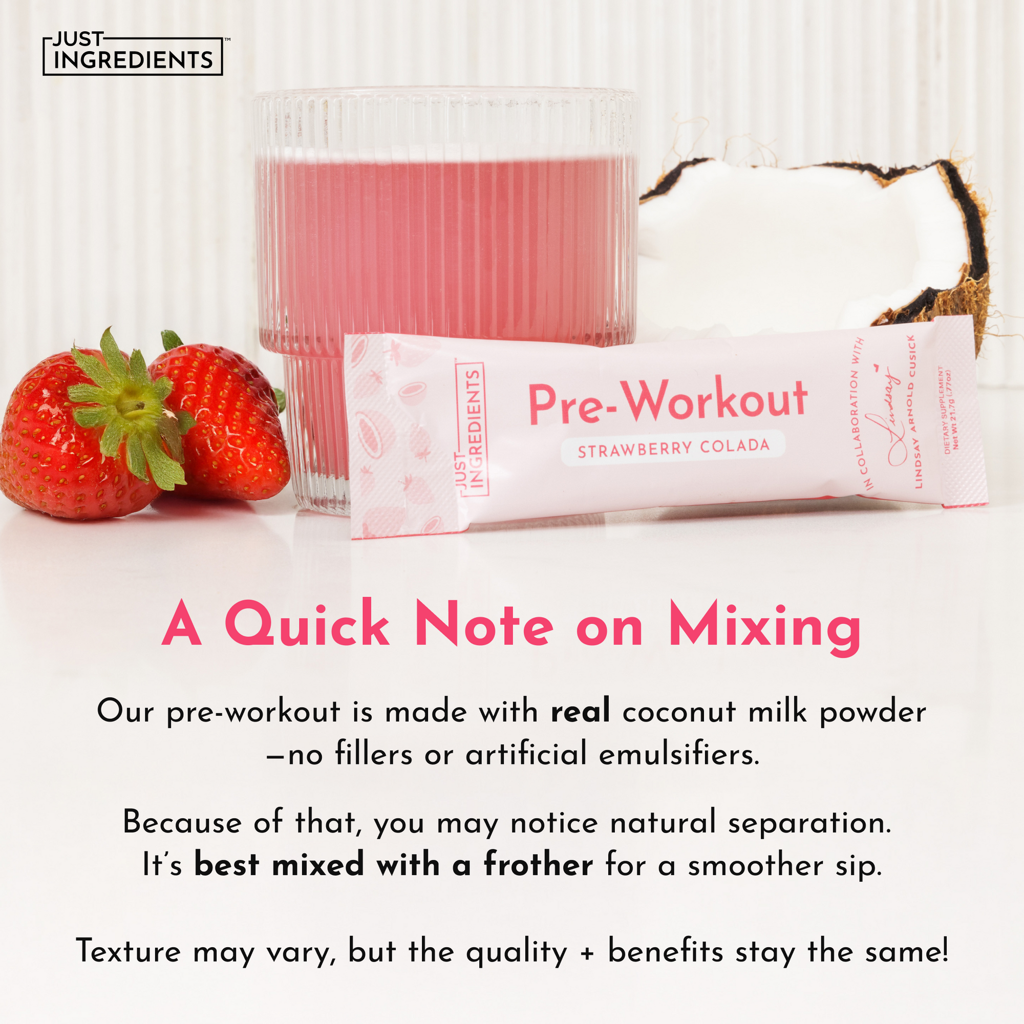 A pink drink in a glass, a packet of Strawberry Colada Pre-Workout, and fresh strawberries on a white surface.