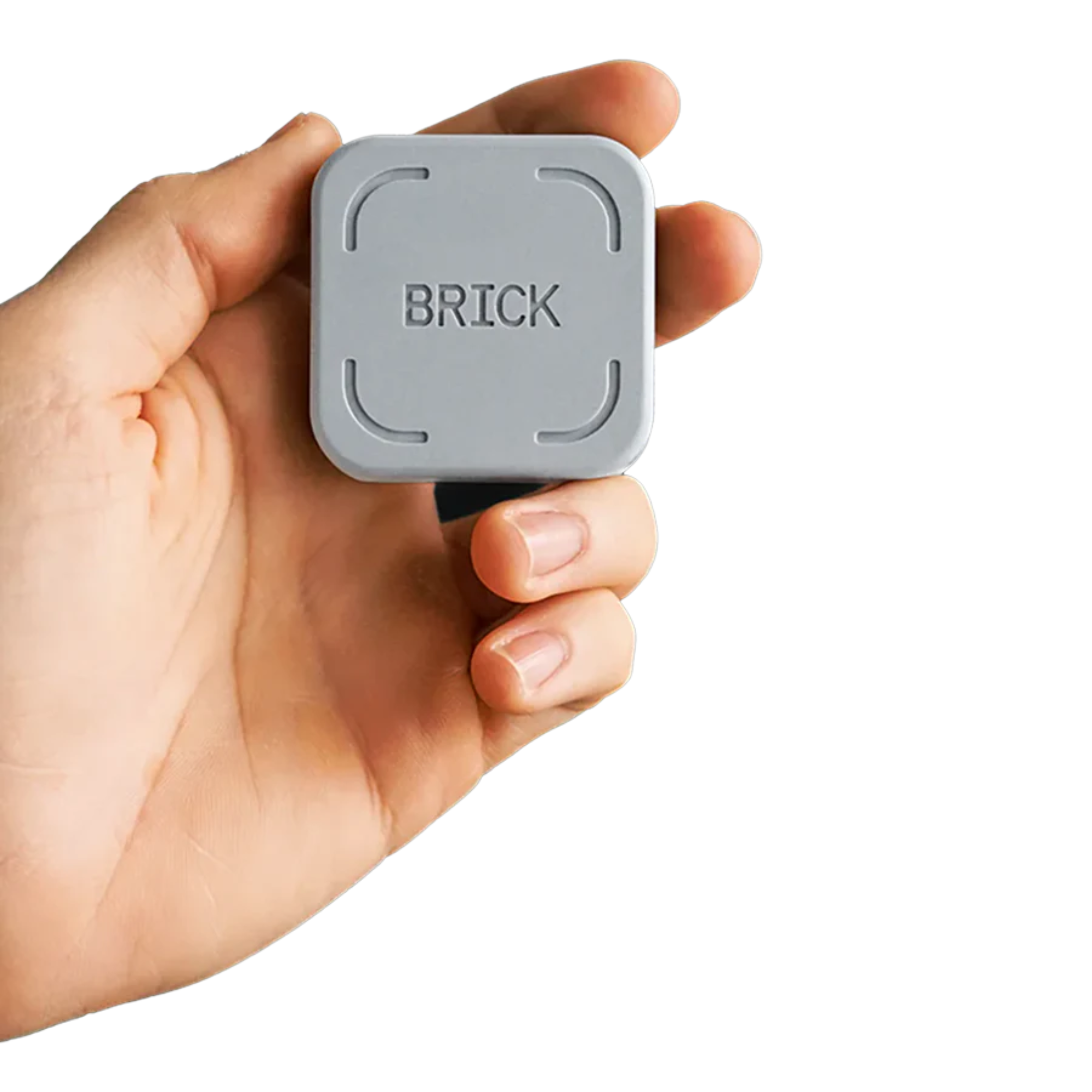 A person holds a small gray square device with the word "BRICK" embossed on the top.