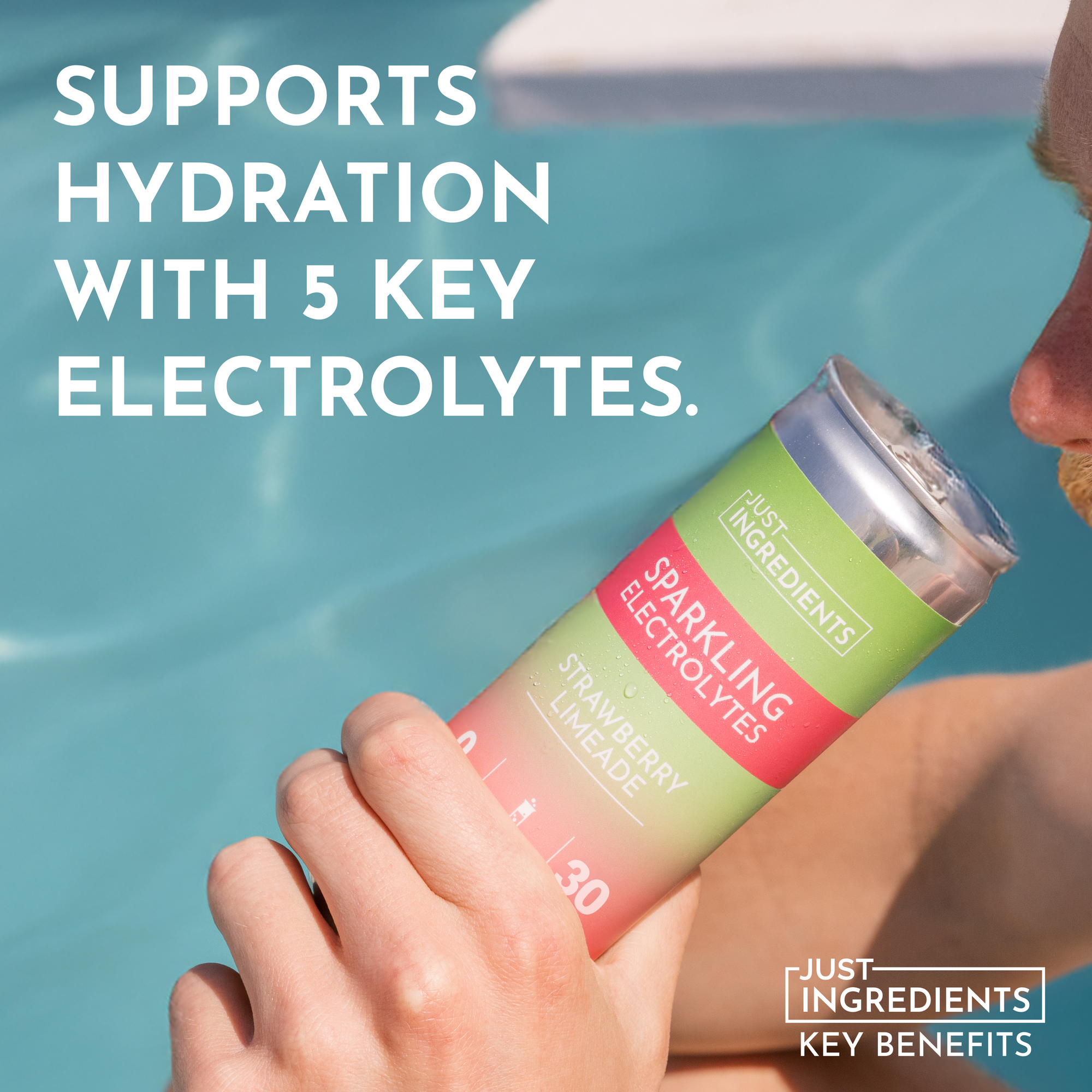 A hand holds a can of Strawberry Limeade Sparkling Electrolytes near a pool.